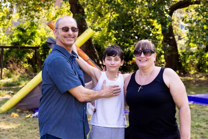 A father, son, and mother smiling