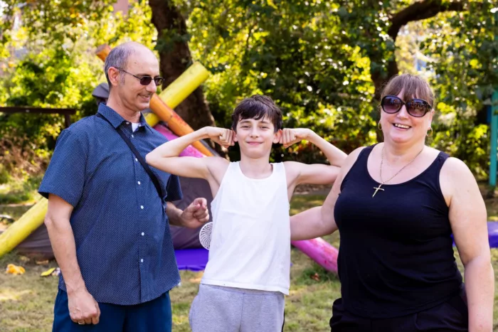 parents smiling with their child in a park