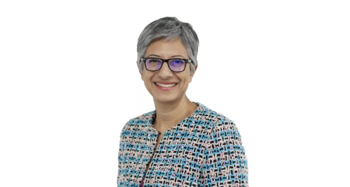 Katie Ghose is photographed from the waist-up.